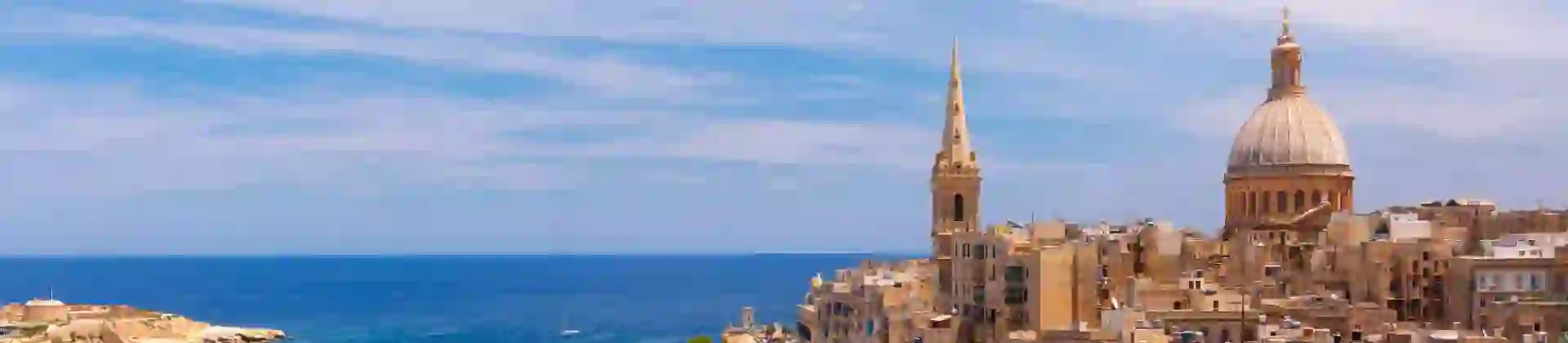 View from above the golden domes of churches and roofs in Valletta, Malta
