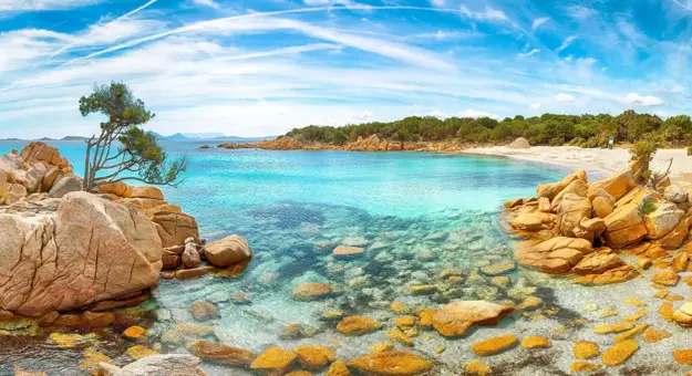 Costa Smeralda seascape in Sardinia, showing the clear blue water and rocks in the forefront