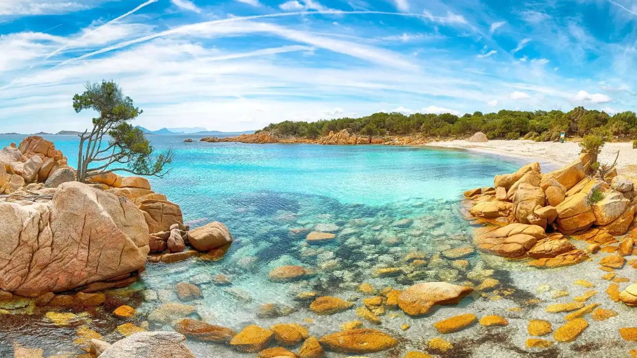 Costa Smeralda seascape in Sardinia, showing the clear blue water and rocks in the forefront