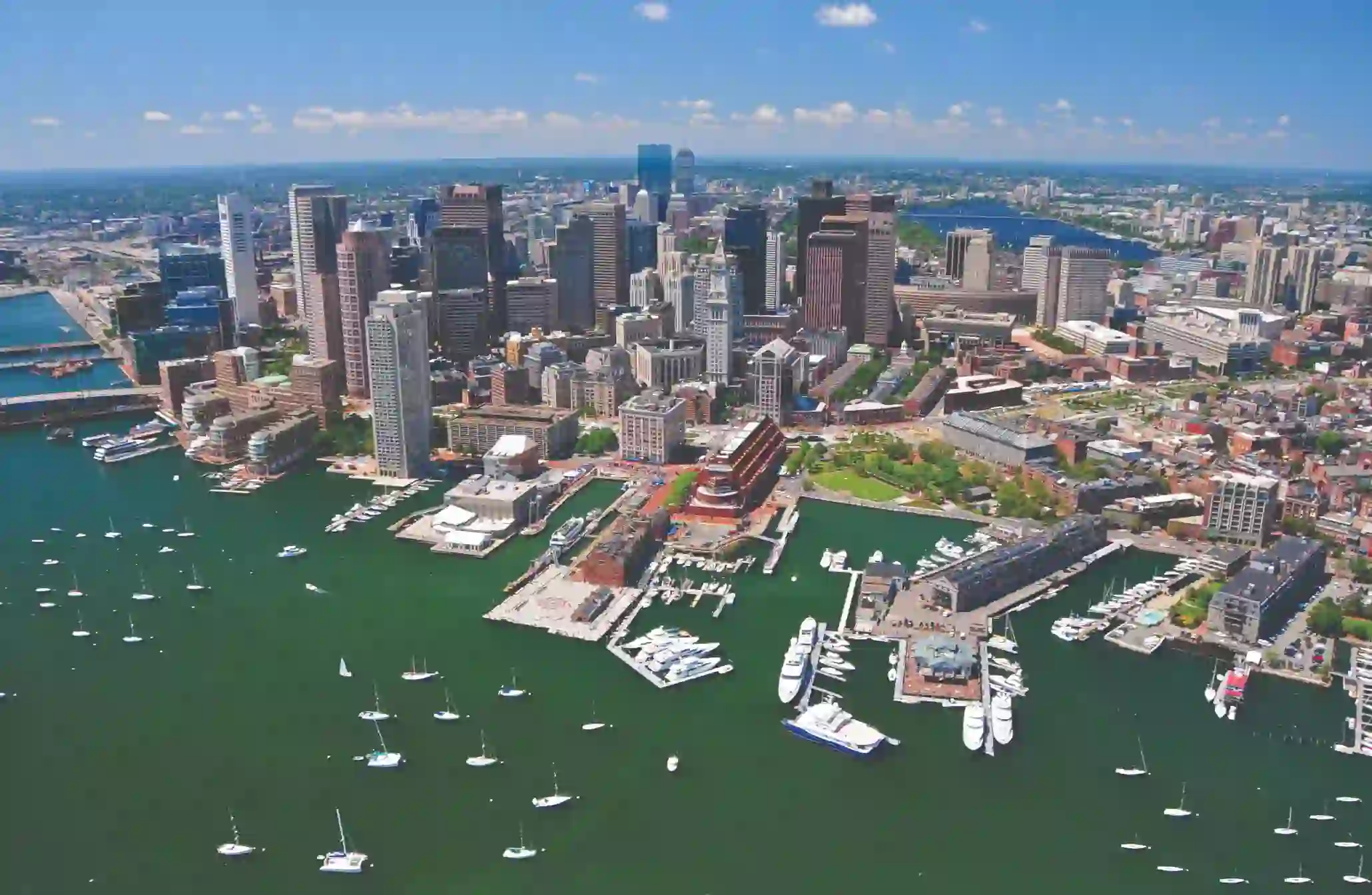 Aerial view of Boston's city skyline and harbour with moored boats