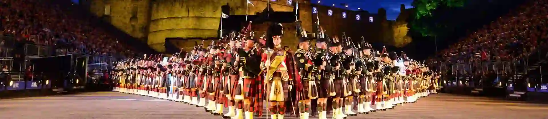 The Royal Edinburgh Military Tattoo lined up in formation infront of Edinburgh castle night time