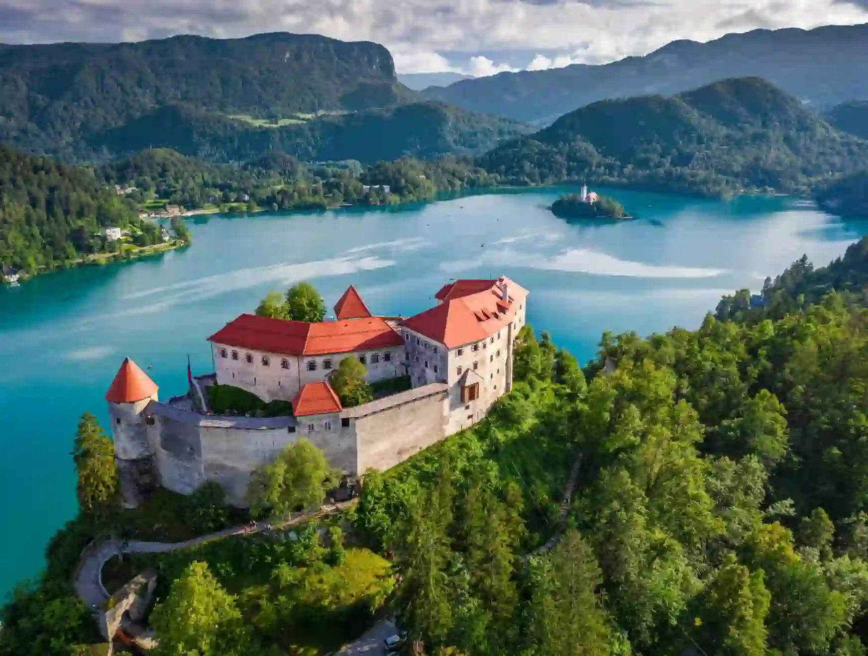 Bled Castle in Slovenia overlooking Lake Bled, with a small island church and surrounding forested mountains