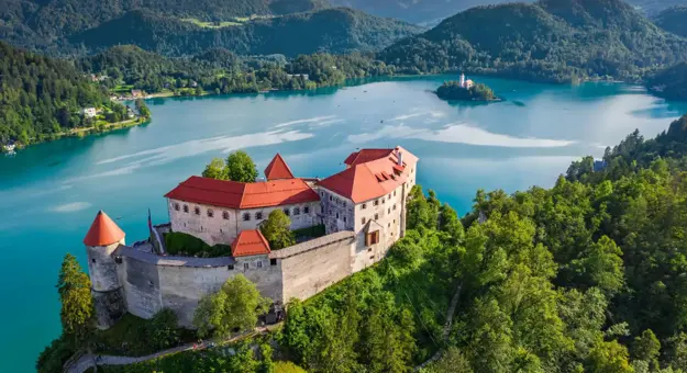 Bled Castle in Slovenia overlooking Lake Bled, with a small island church and surrounding forested mountains