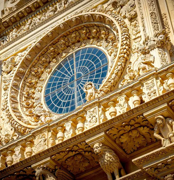 Detailed close-up of the ornate façade of the Basilica of Santa Croce in Lecce