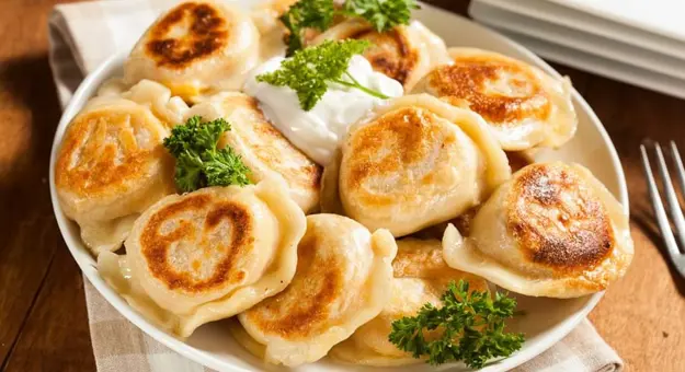 Polish pierogis with sour cream