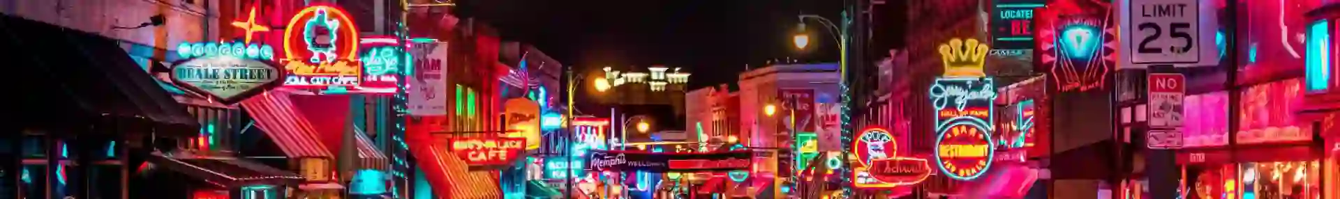 Vibrant night scene on Beale Street in Memphis, with neon signs glowing above blues clubs, bars, and live music venues, and crowds of people walking along the historic street