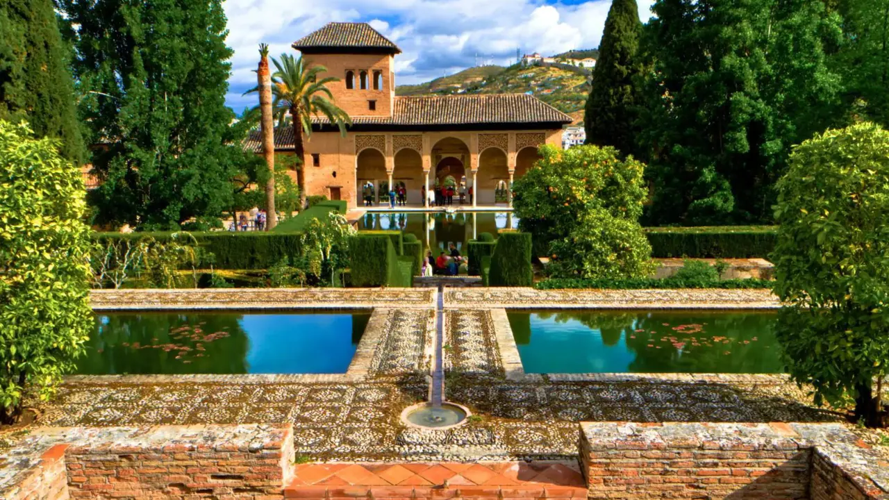 Ornate gardens and reflecting pools at the Alhambra Palace in Granada