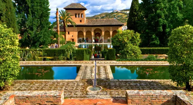 Ornate gardens and reflecting pools at the Alhambra Palace in Granada