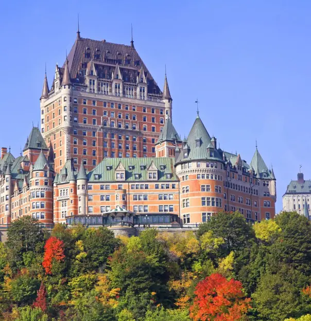 The Château Frontenac, a grand historic hotel in Quebec City, Canada, with its distinctive steep green roofs and turrets against a clear sky