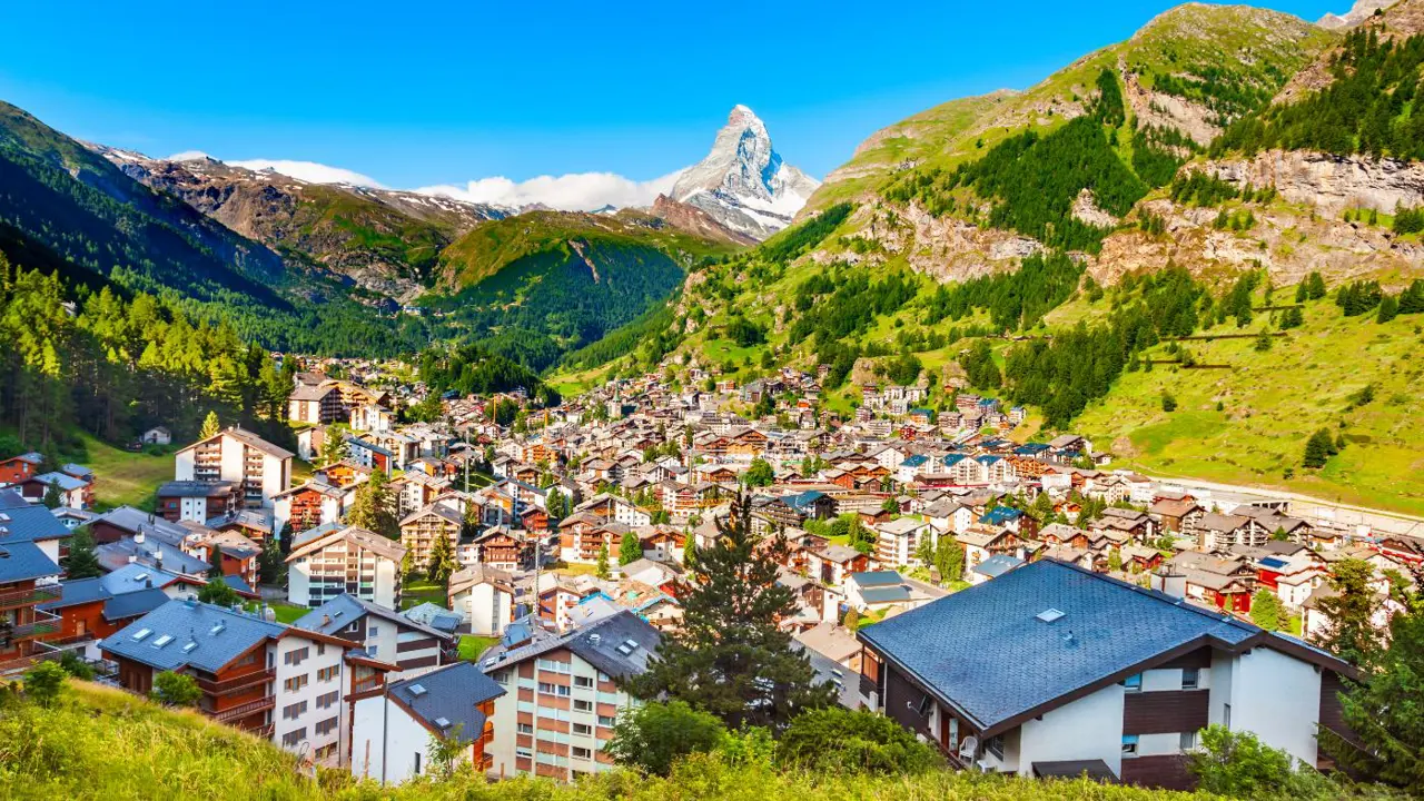 View of Zermatt, Switzerland, showing the town’s buildings in the valley below with the Matterhorn towering in the distance