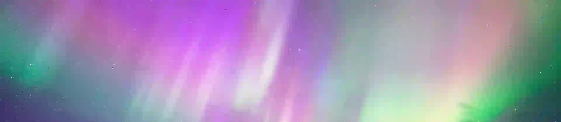 Purple Northern Lights with hints of green, and snowy land below