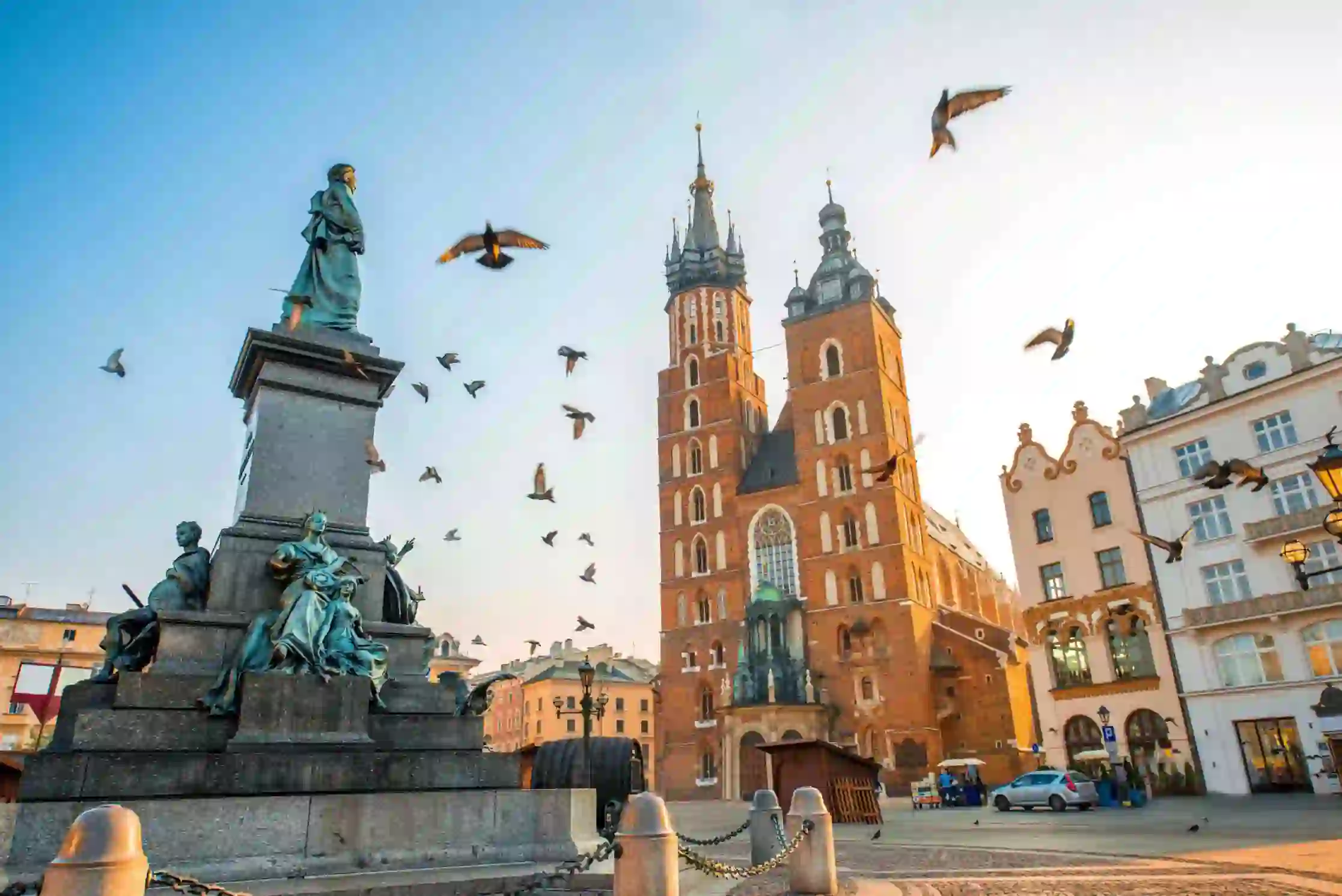 The Main Square in Kraków, Poland, with historic buildings and St. Mary's Basilica in the background