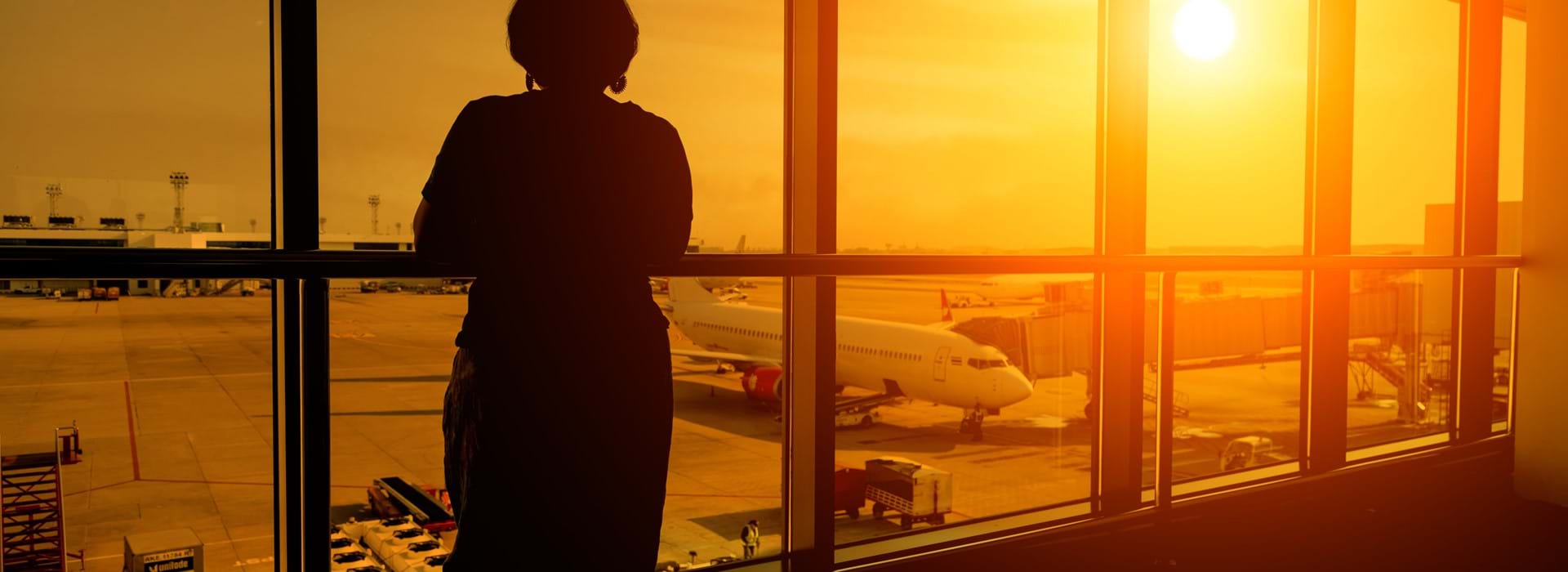 Person looking out the window in an airport