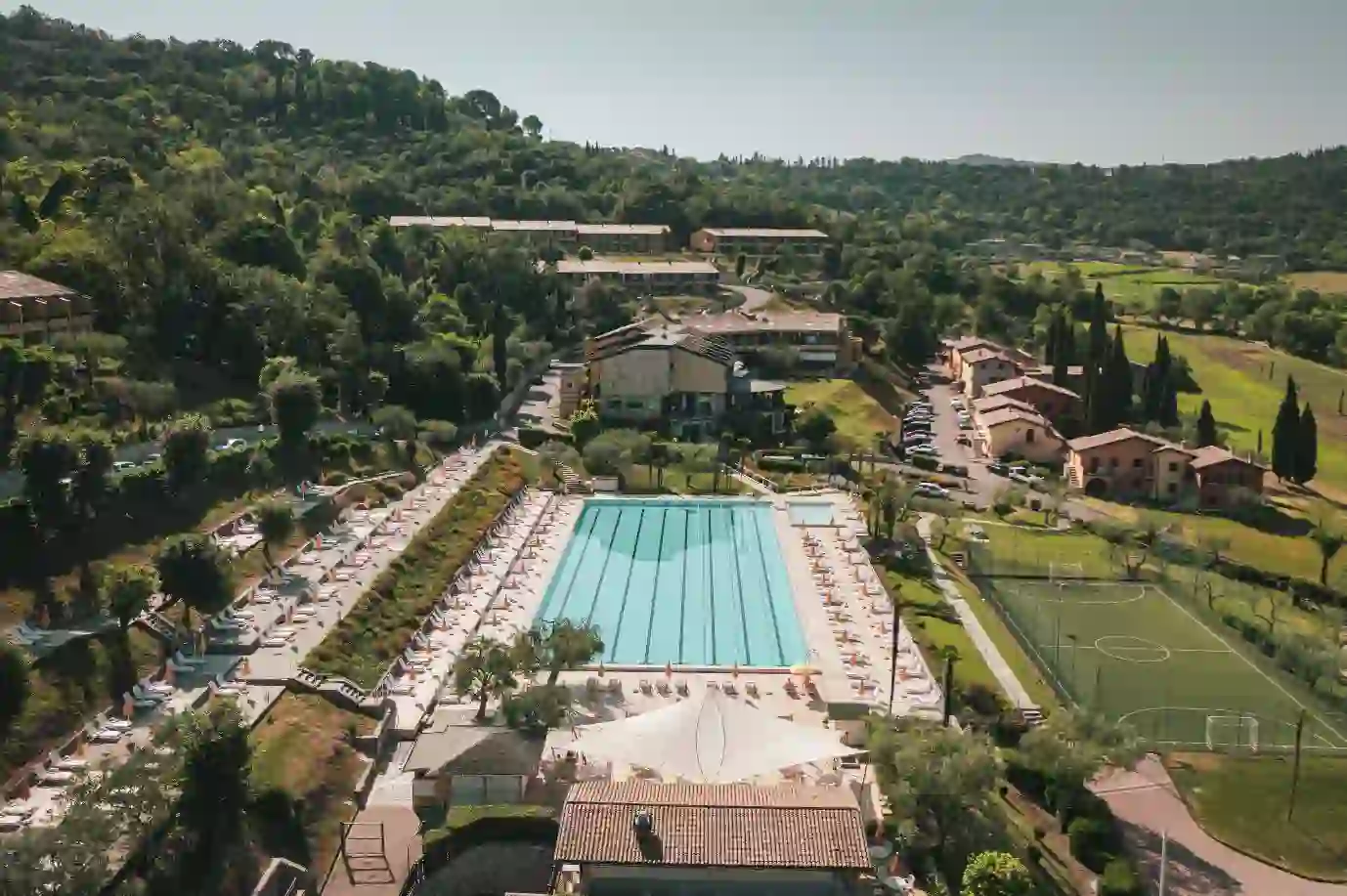 A view of the outdoor swimming pool at Hotel Poiano Resort