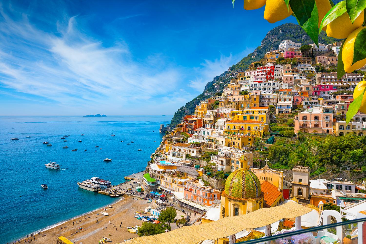 Colourful cliffside village of Positano on the Amalfi Coast, Italy, with pastel-coloured houses cascading down steep hills towards the sparkling blue Mediterranean Sea