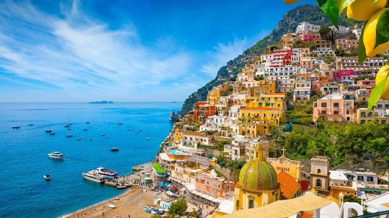 Colourful cliffside village of Positano on the Amalfi Coast, Italy, with pastel-coloured houses cascading down steep hills towards the sparkling blue Mediterranean Sea