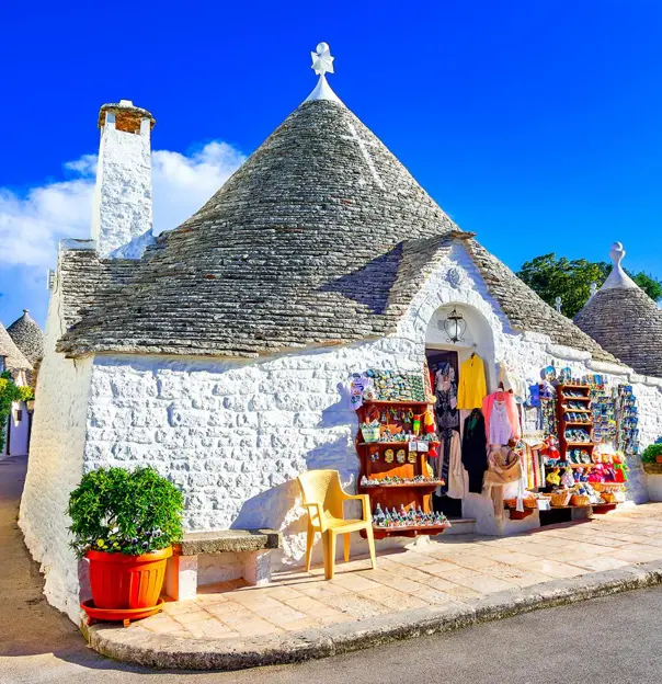 Traditional whitewashed, cone-roofed houses, lined along a narrow street in Alberobello, Puglia