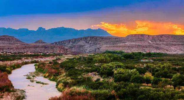 A scenic view of the Rio Grande winding through Big Bend National Park at sunset