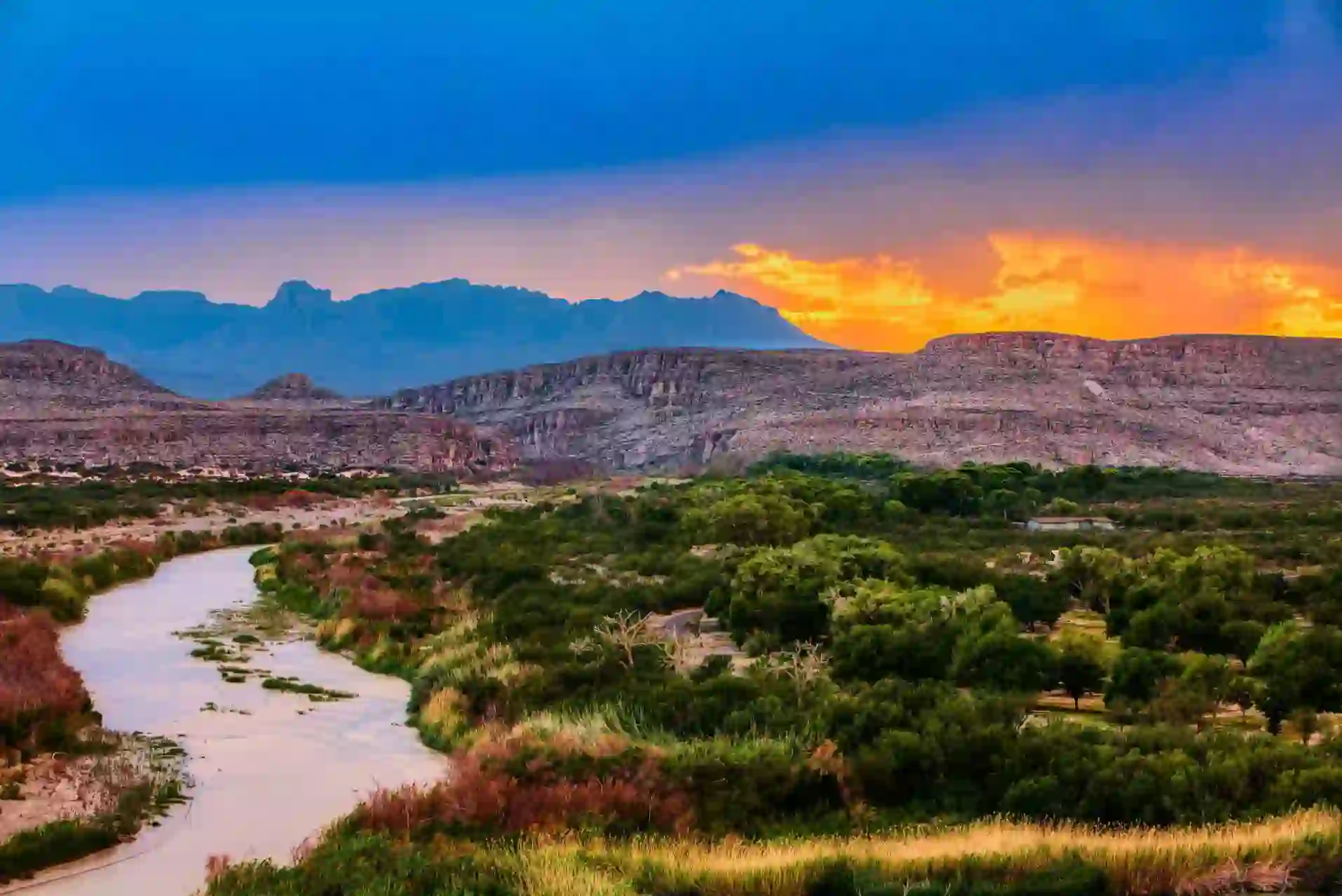 A scenic view of the Rio Grande winding through Big Bend National Park at sunset