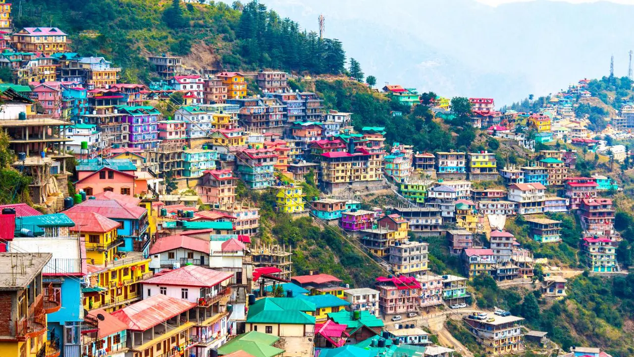 A hillside in Shimla, India, lined with bright, colourful buildings
